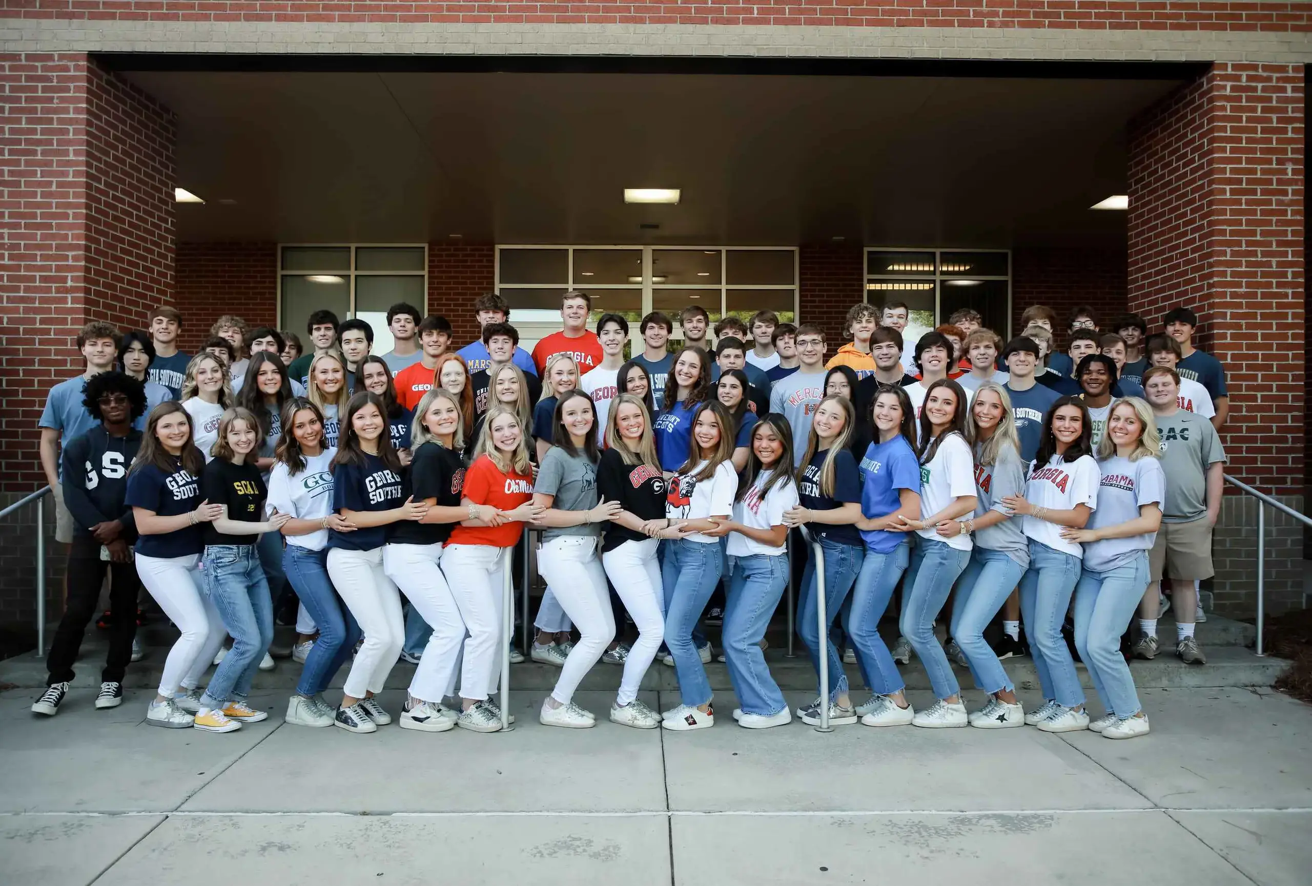 Group shot of seniors with college shirts.