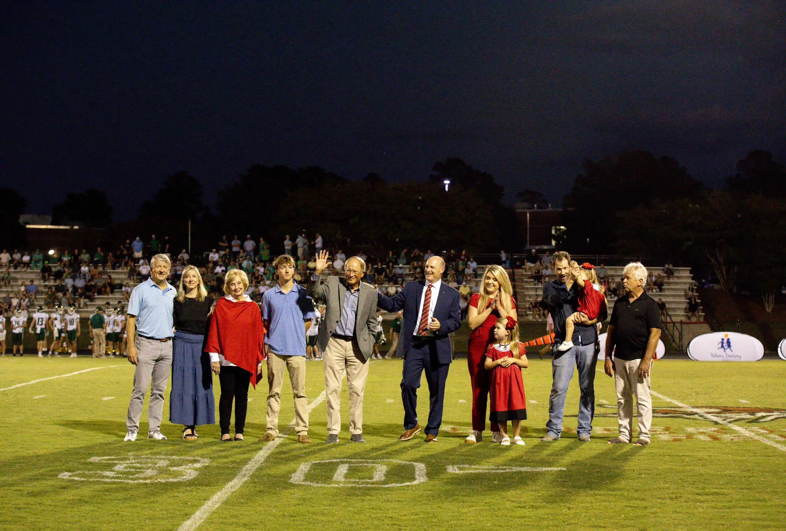 Alumni award winners recognized on the football field. 