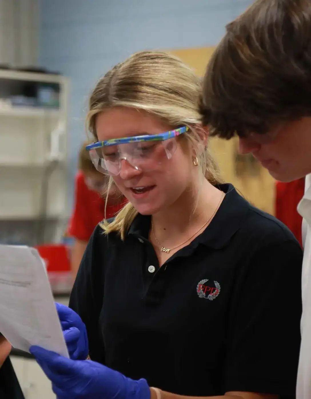 Students in physics lab conduct and experiment.