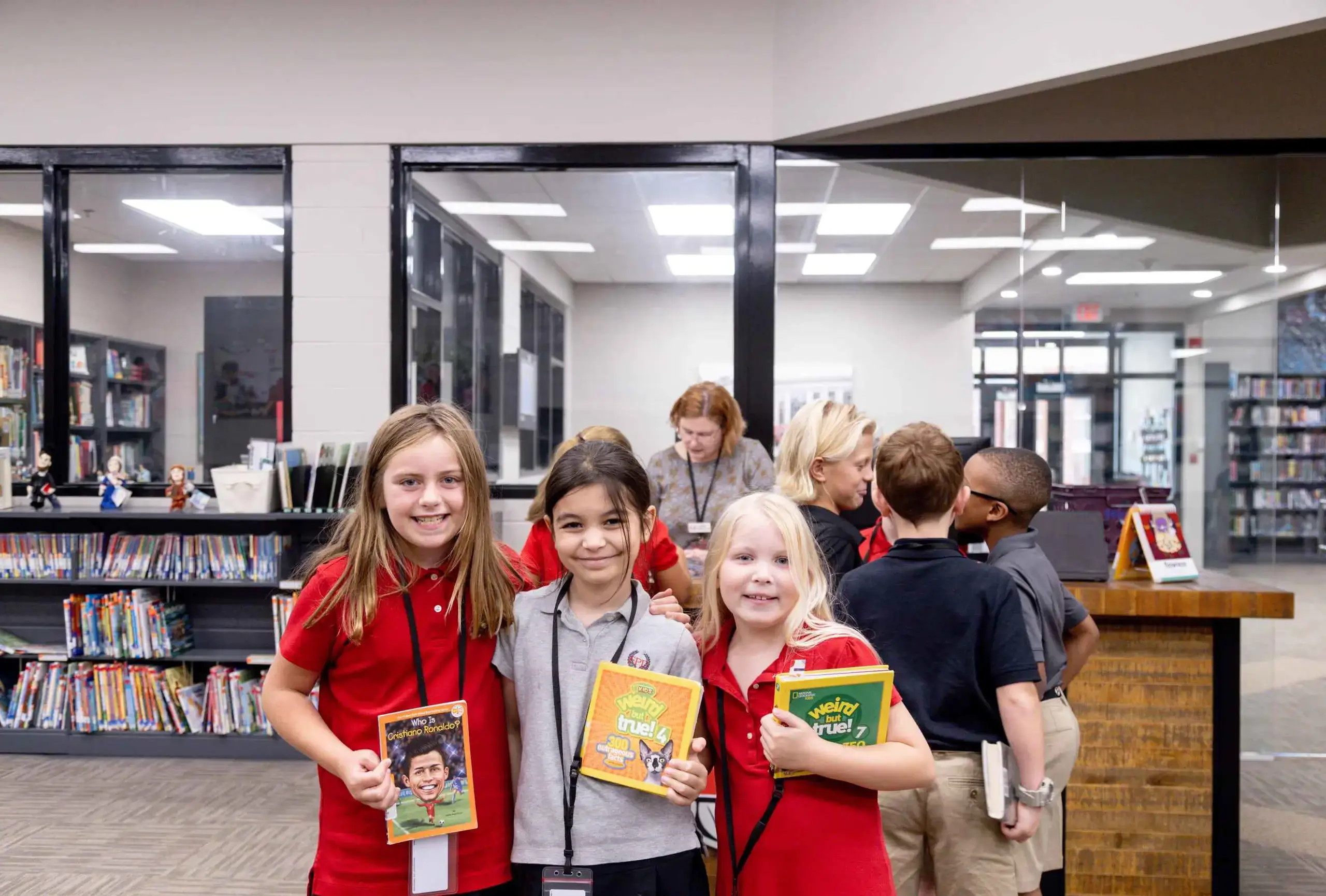 Students check out books in the library.