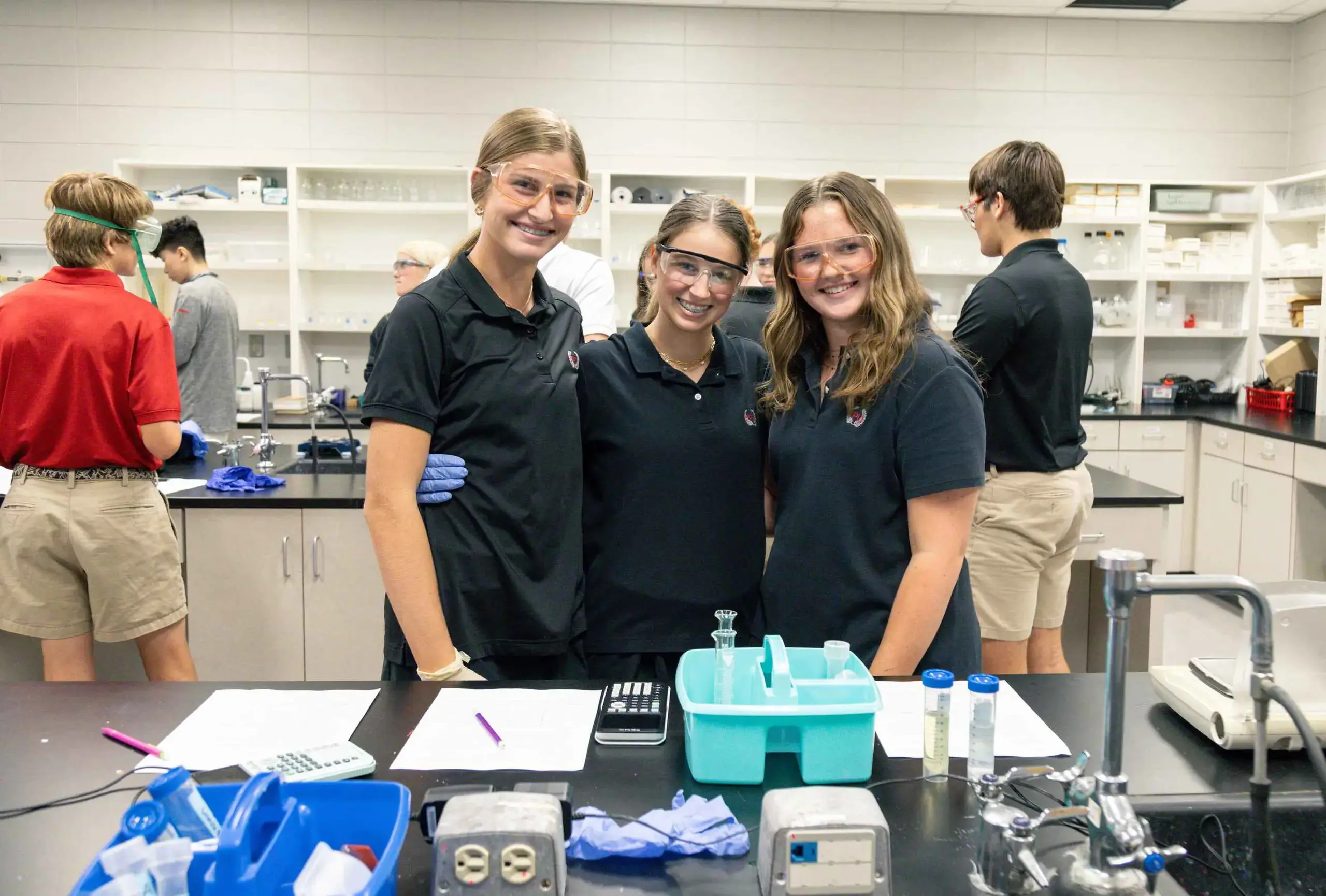 Three students in a science lab.